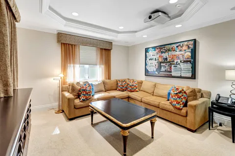 a front view of a house with garden and sitting area