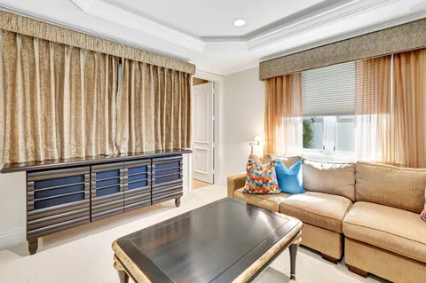 an aerial view of a house with a garden and lake view