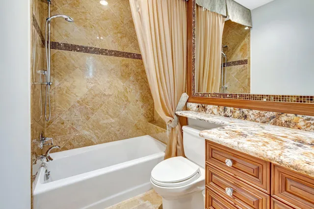 an aerial view of a house with a yard outdoor seating and lake view