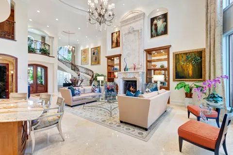 a living room with fireplace furniture and a chandelier