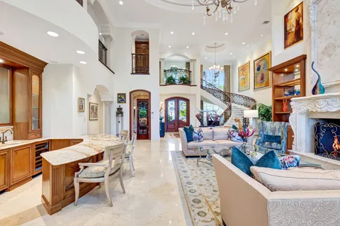 a living room with fireplace furniture and a large window