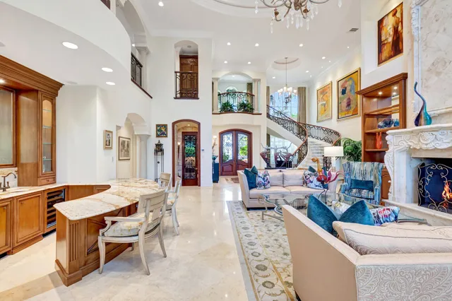 a living room with fireplace furniture and a large window