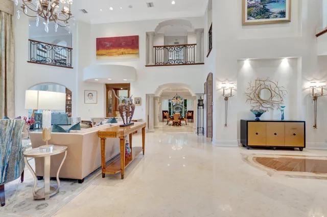 a living room with furniture and a mirror