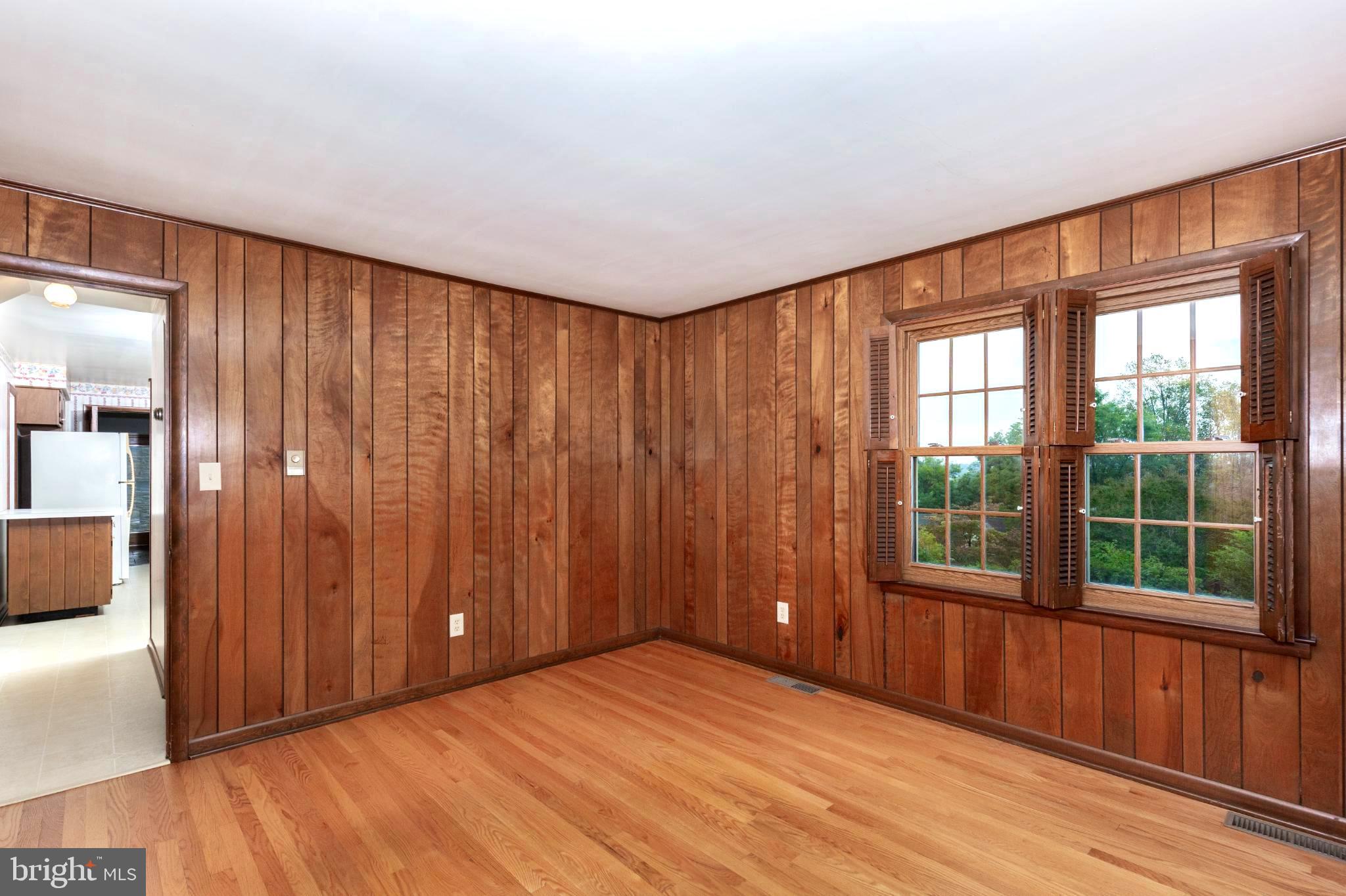 61 Ridge Road Westminster, MD 21157 - Photo 13 of 45 a view of an empty room with wooden floor and a window