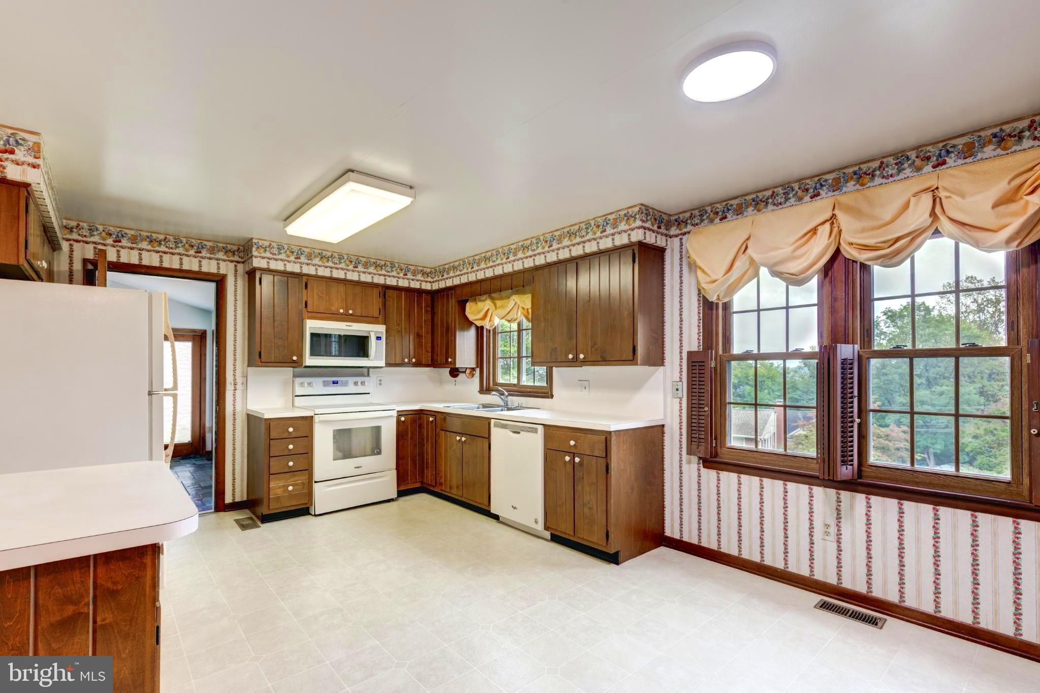 61 Ridge Road Westminster, MD 21157 - Photo 17 of 45 a large kitchen with a large window and stainless steel appliances