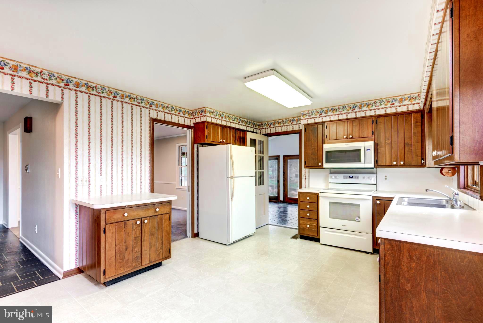 61 Ridge Road Westminster, MD 21157 - Photo 18 of 45 a kitchen with a refrigerator sink and stove