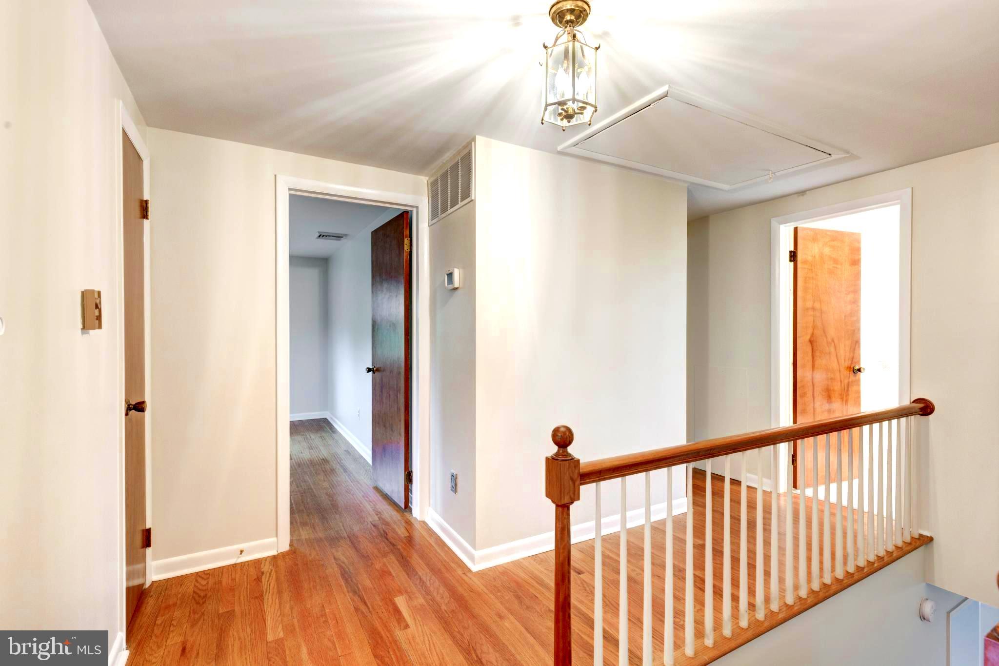 61 Ridge Road Westminster, MD 21157 - Photo 25 of 45 a view of a hallway with wooden floor and staircase