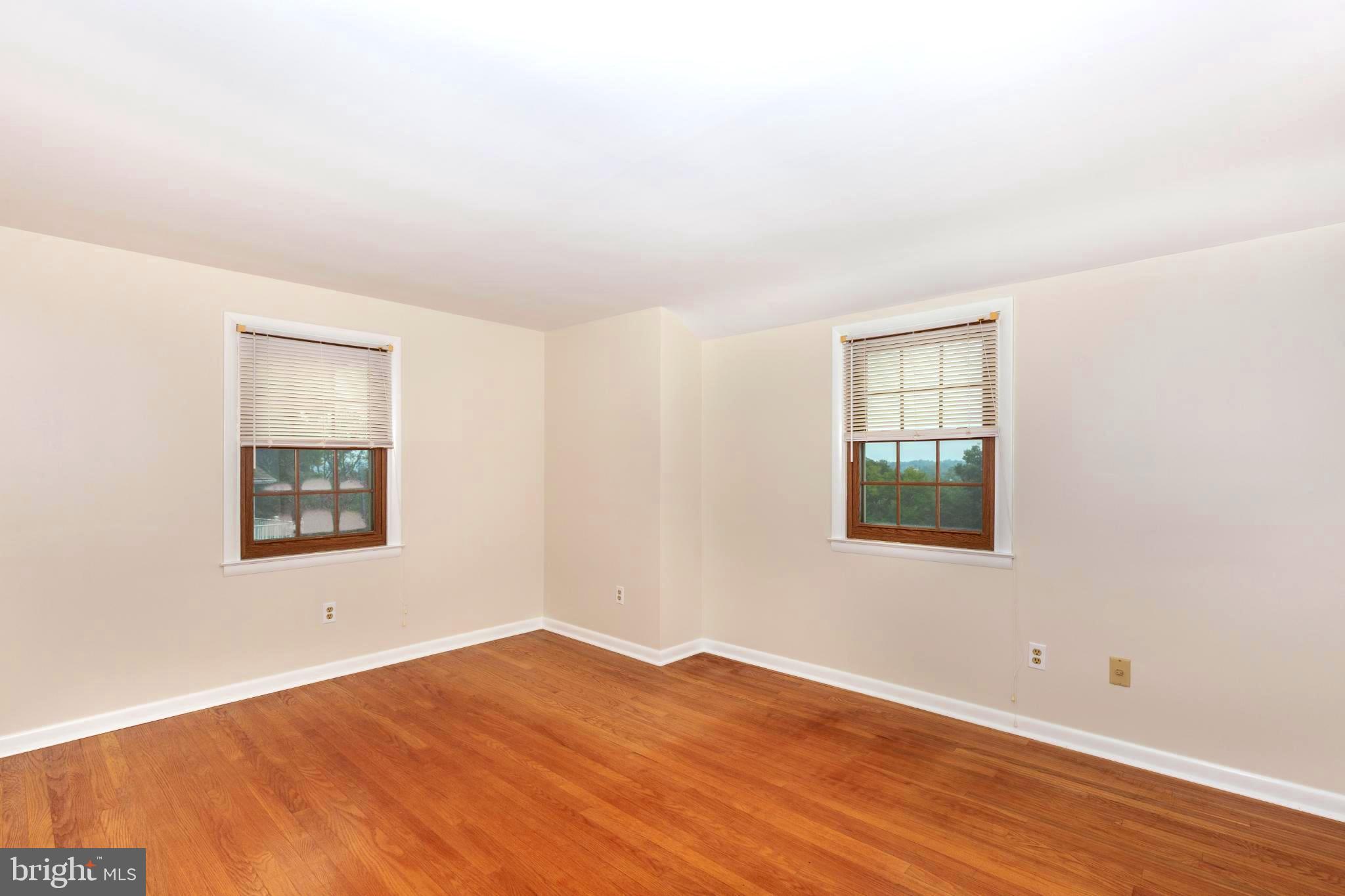 61 Ridge Road Westminster, MD 21157 - Photo 28 of 45 an empty room with wooden floor and windows