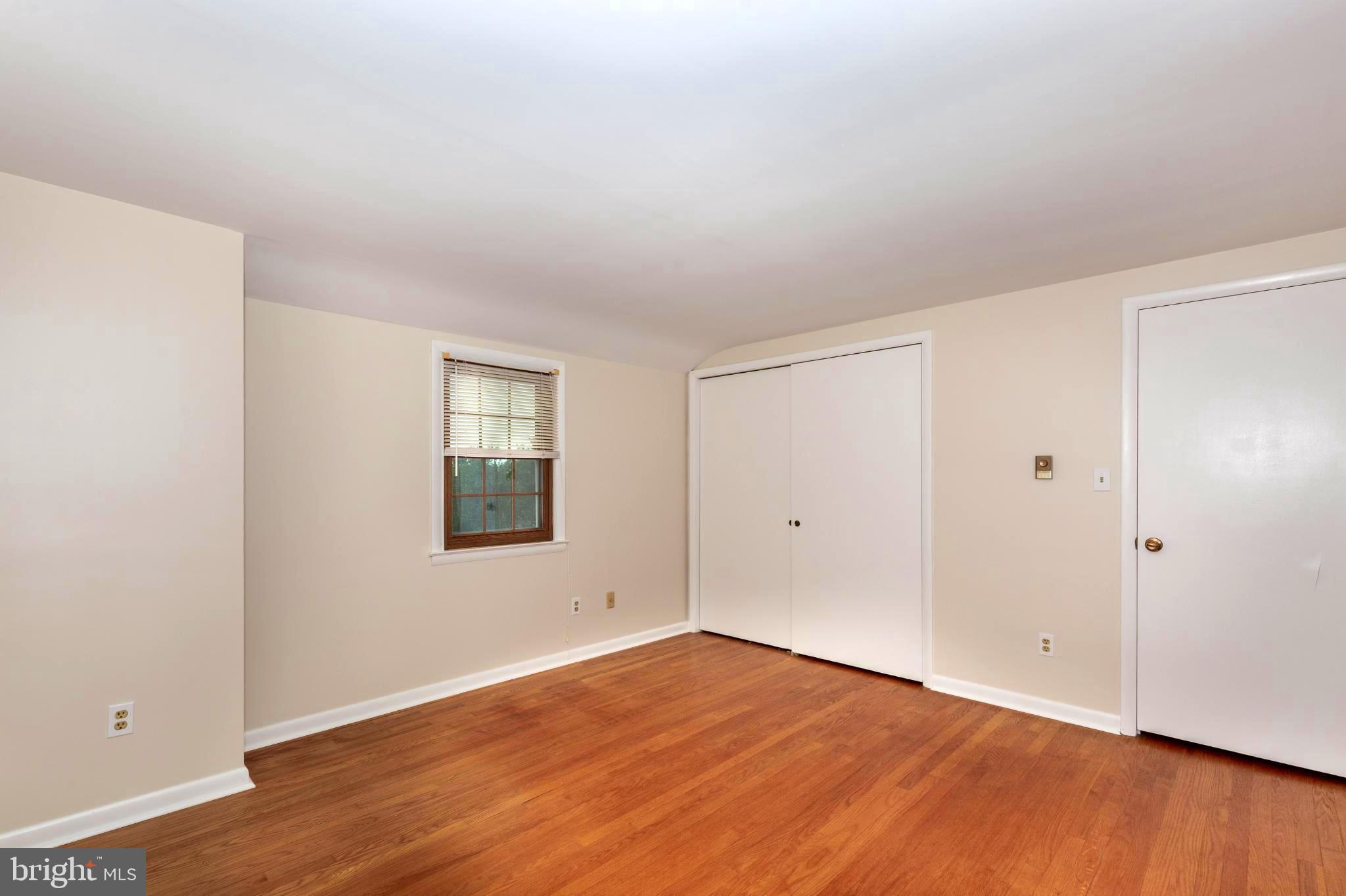 61 Ridge Road Westminster, MD 21157 - Photo 29 of 45 a view of an empty room with wooden floor and a window