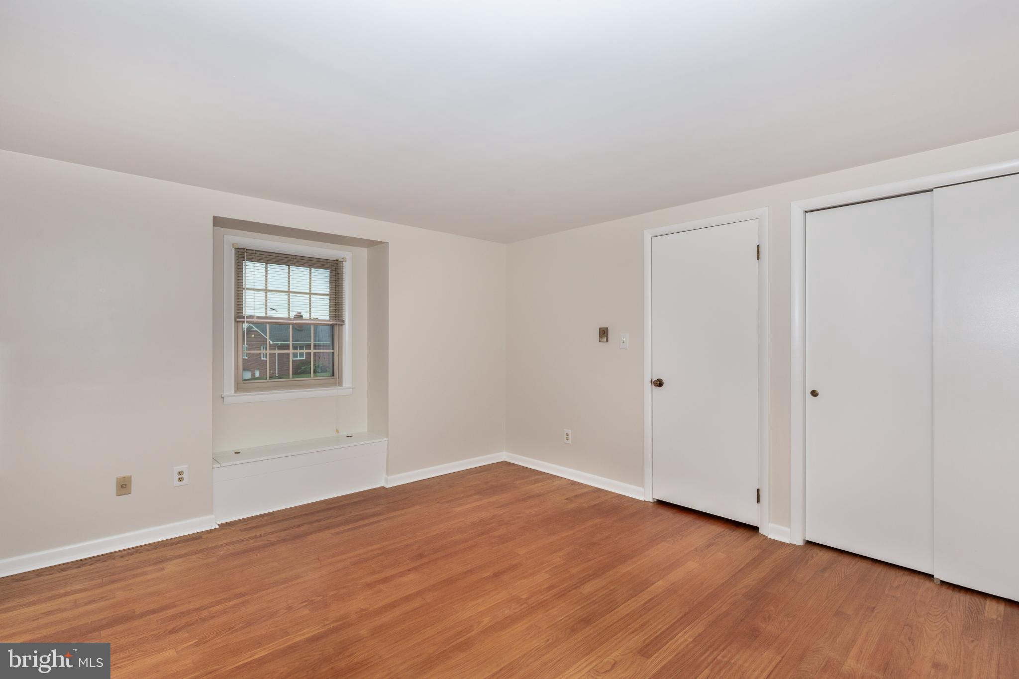 61 Ridge Road Westminster, MD 21157 - Photo 33 of 45 a view of an empty room with wooden floor and a window