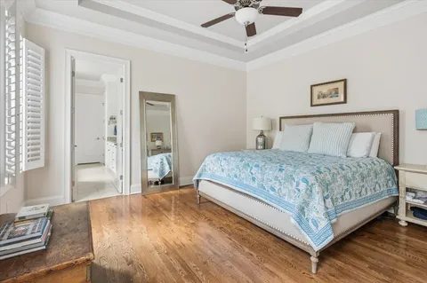 a bedroom with a large bed and a chandelier