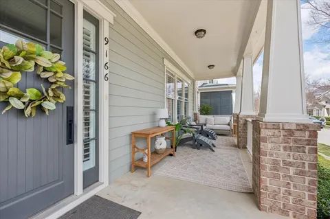 a view of a patio with table and chairs and potted plants