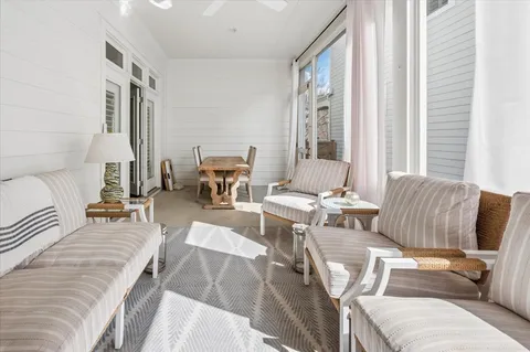 a living room with furniture and large windows