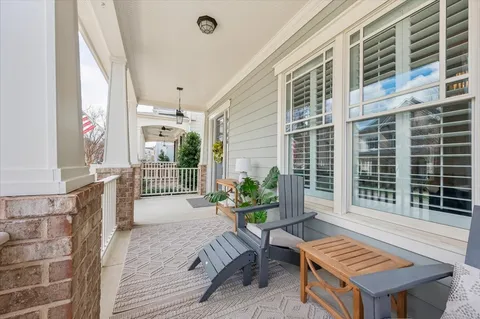 a balcony with furniture and potted plants