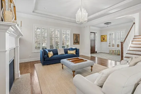 a living room with furniture and a chandelier