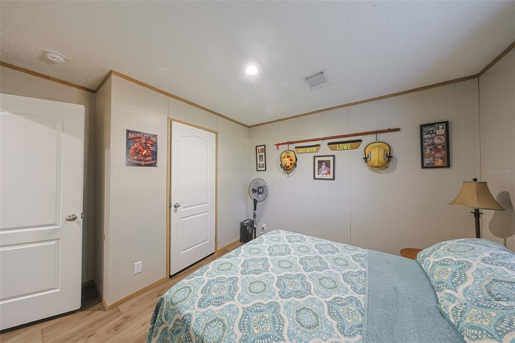 12124 Redrose Avenue Weeki Wachee, FL 34614 - Photo 15 of 57 a bedroom with a bed and a dresser