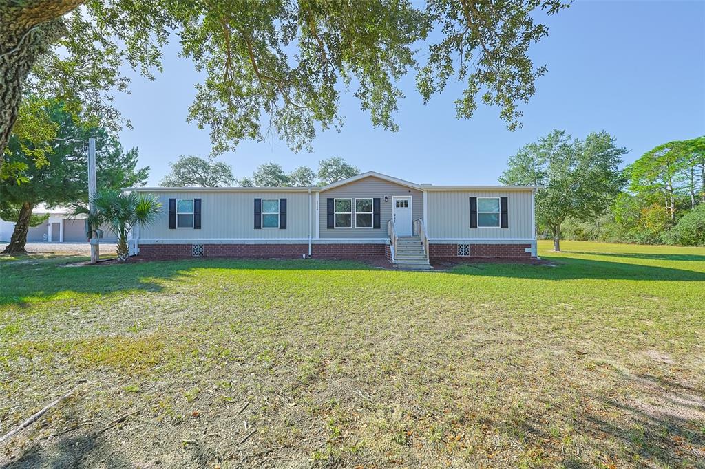 12124 Redrose Avenue Weeki Wachee, FL 34614 - Photo 3 of 57 a house view with a garden space