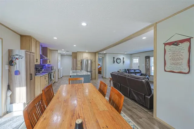 a view of a house with backyard and trees
