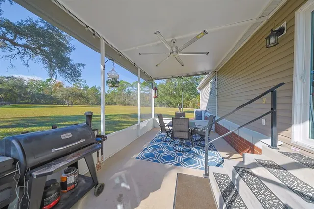 a roof deck with table and chairs and wooden floor