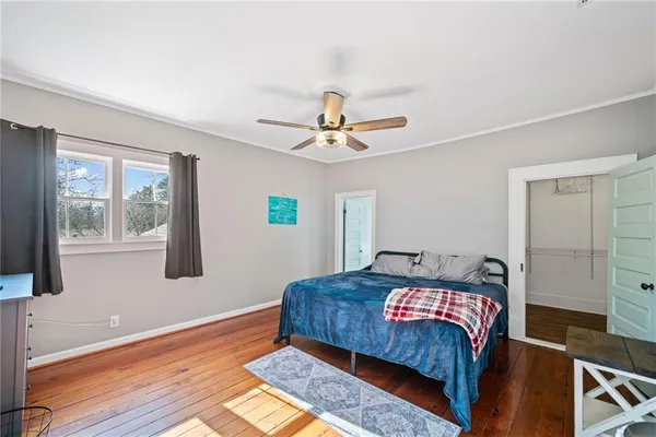 a living room with a bed furniture and next to a window