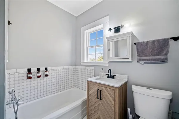 a bathroom with a sink a toilet and bathtub