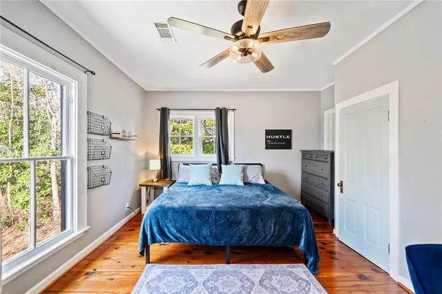 a bedroom with a bed a chandelier and a window