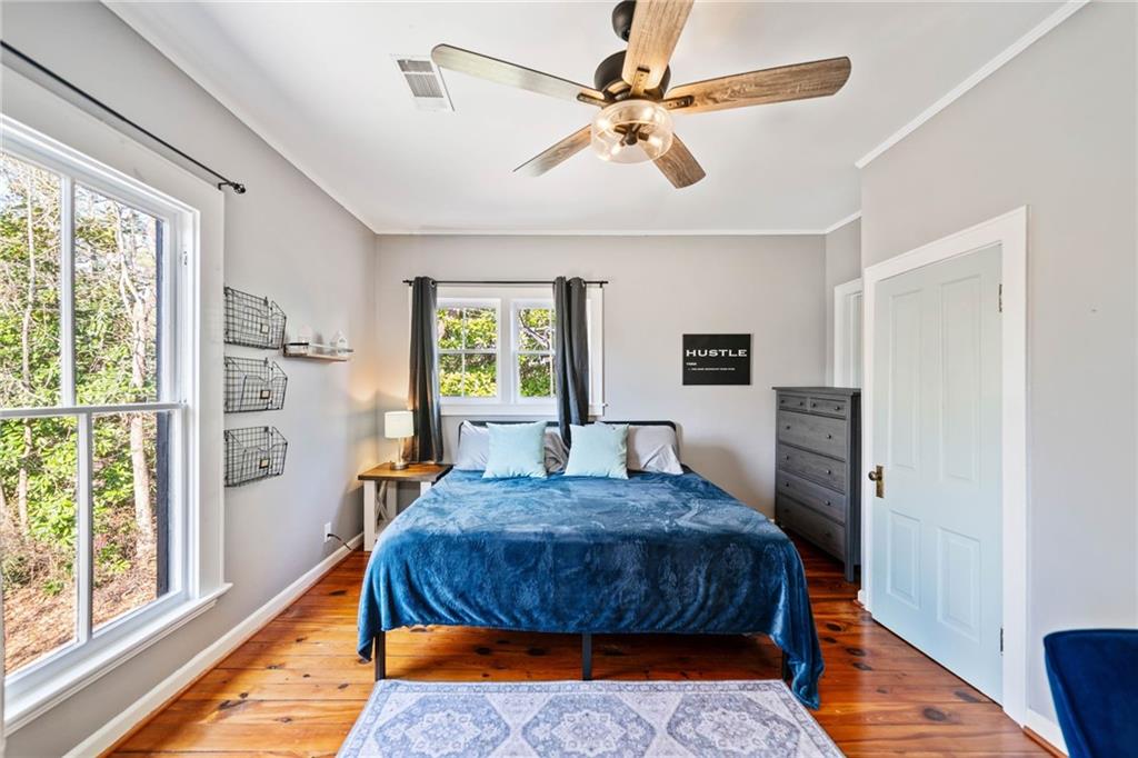 634 South Main Street Jasper, GA 30143 - Photo 15 of 39 a bedroom with a bed a chandelier and a window