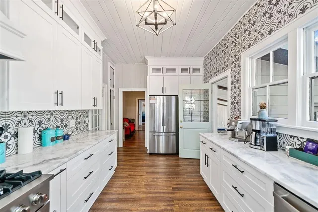 a kitchen with refrigerator and cabinets