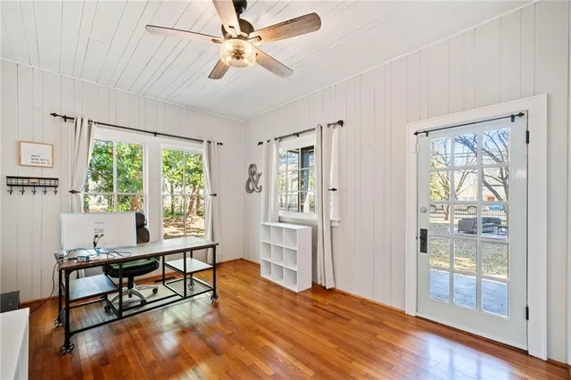 a workspace with wooden floor and a window