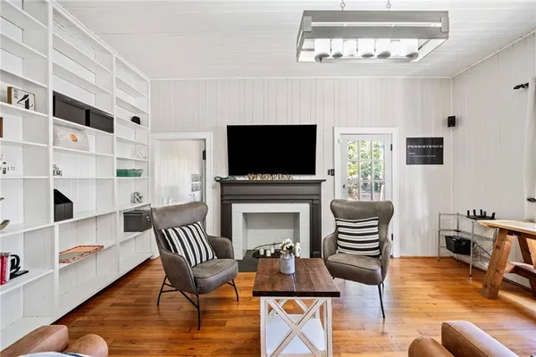 a living room with furniture a fireplace and a flat screen tv