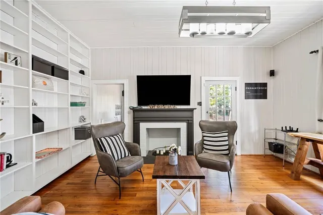 a living room with furniture a fireplace and a flat screen tv
