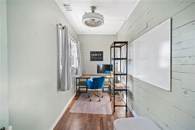 a workspace with furniture window and wooden floor