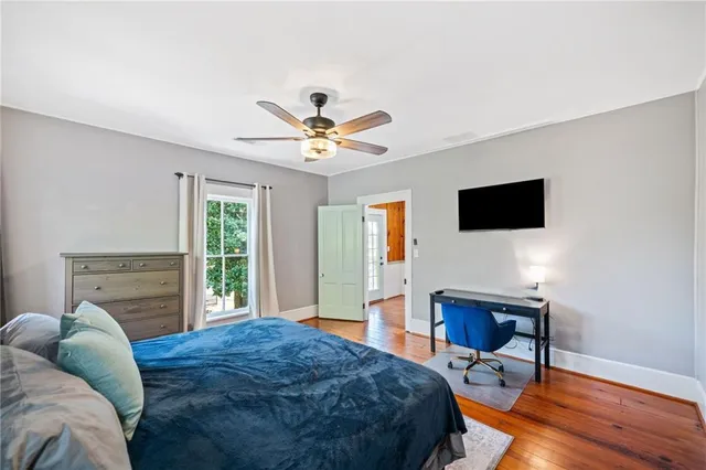 a spacious bedroom with a bed and a television