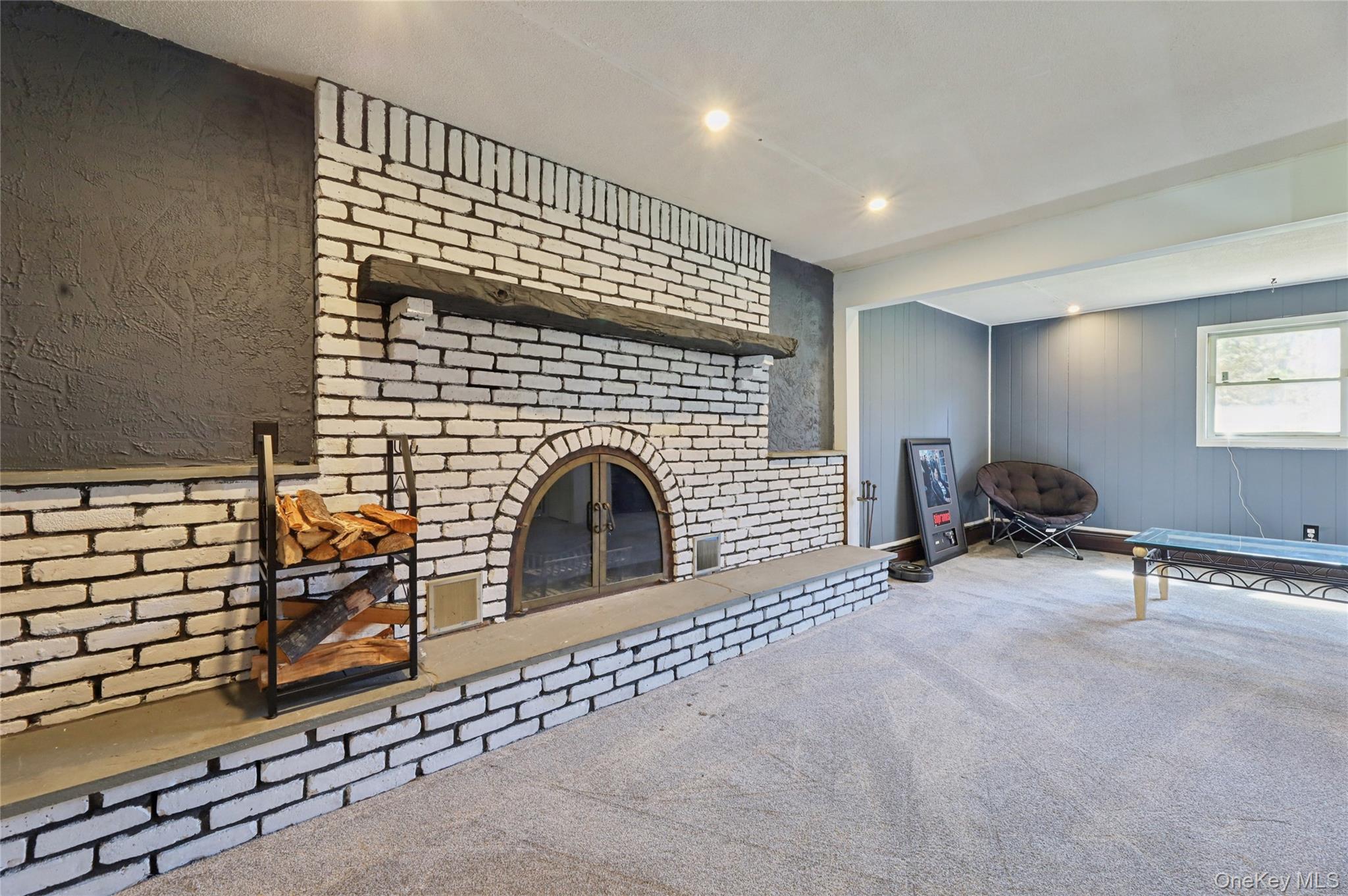 635 South Pascack Road Chestnut Ridge, NY 10977 - Photo 20 of 40 Family room with wood burning fireplace and warm, brick accent wall