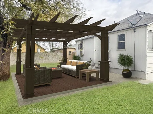 a view of a house with backyard and sitting area