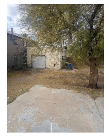 a view of a dirt road and a building