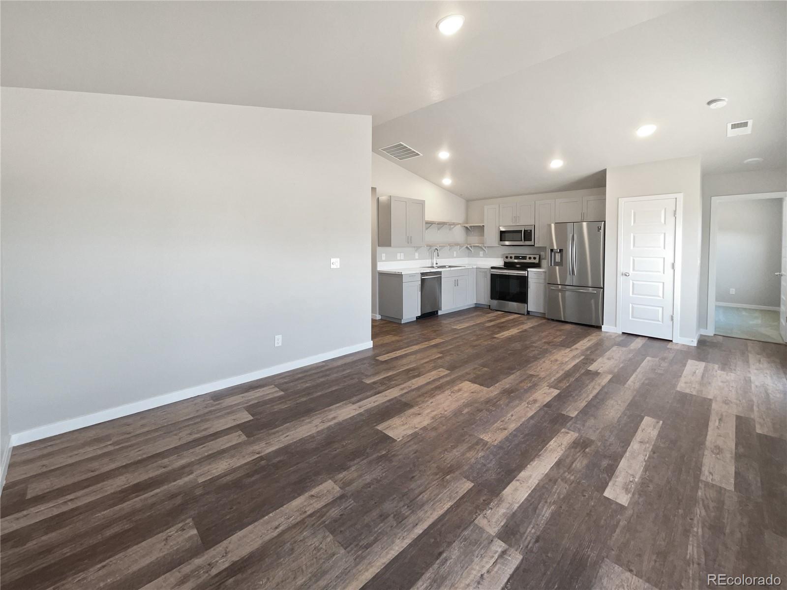 322 Bozeman Trail Ault, CO 80610 - Photo 15 of 19 a view of a kitchen with wooden floor