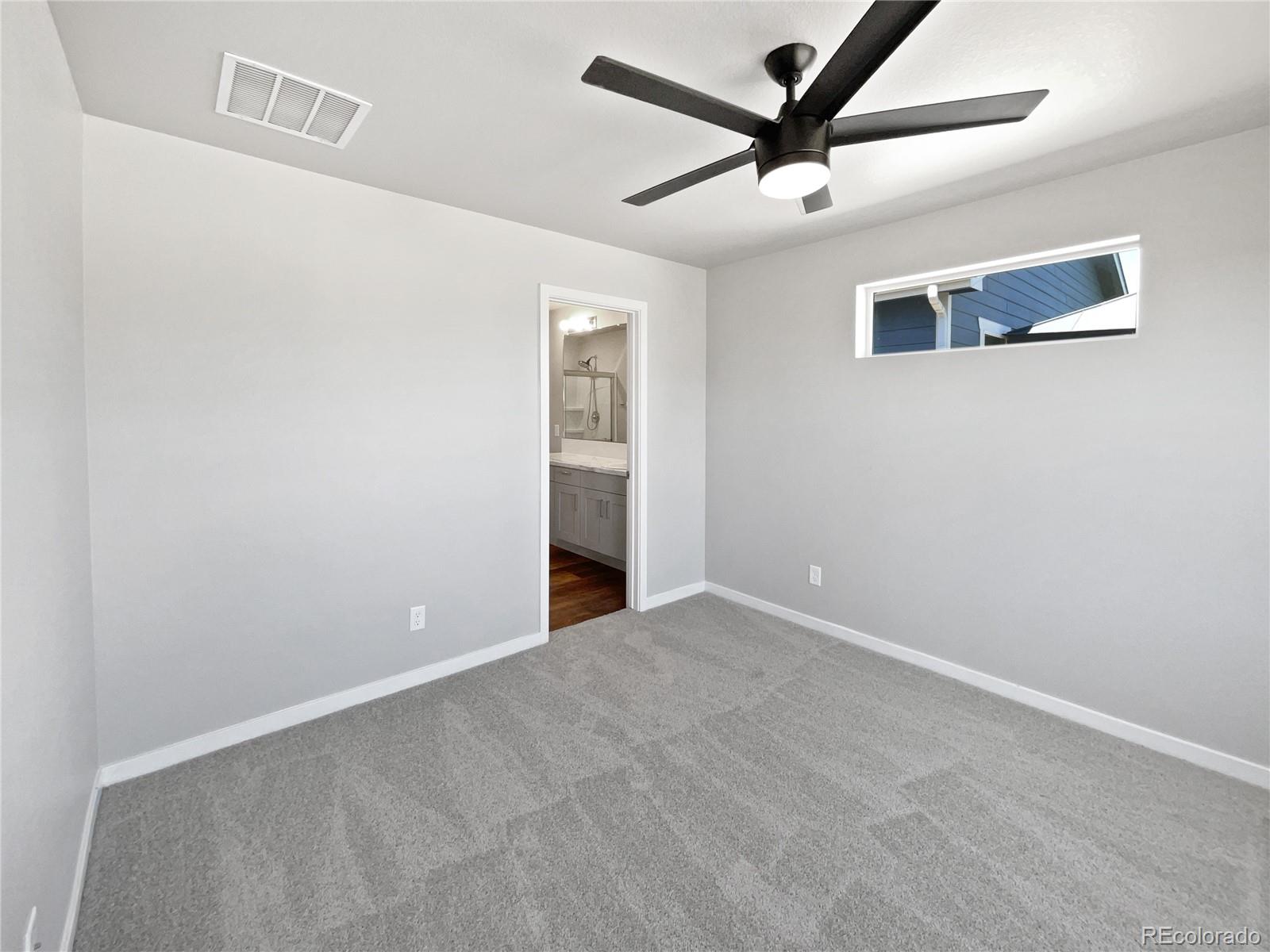 322 Bozeman Trail Ault, CO 80610 - Photo 16 of 19 an empty room with ceiling fan and window
