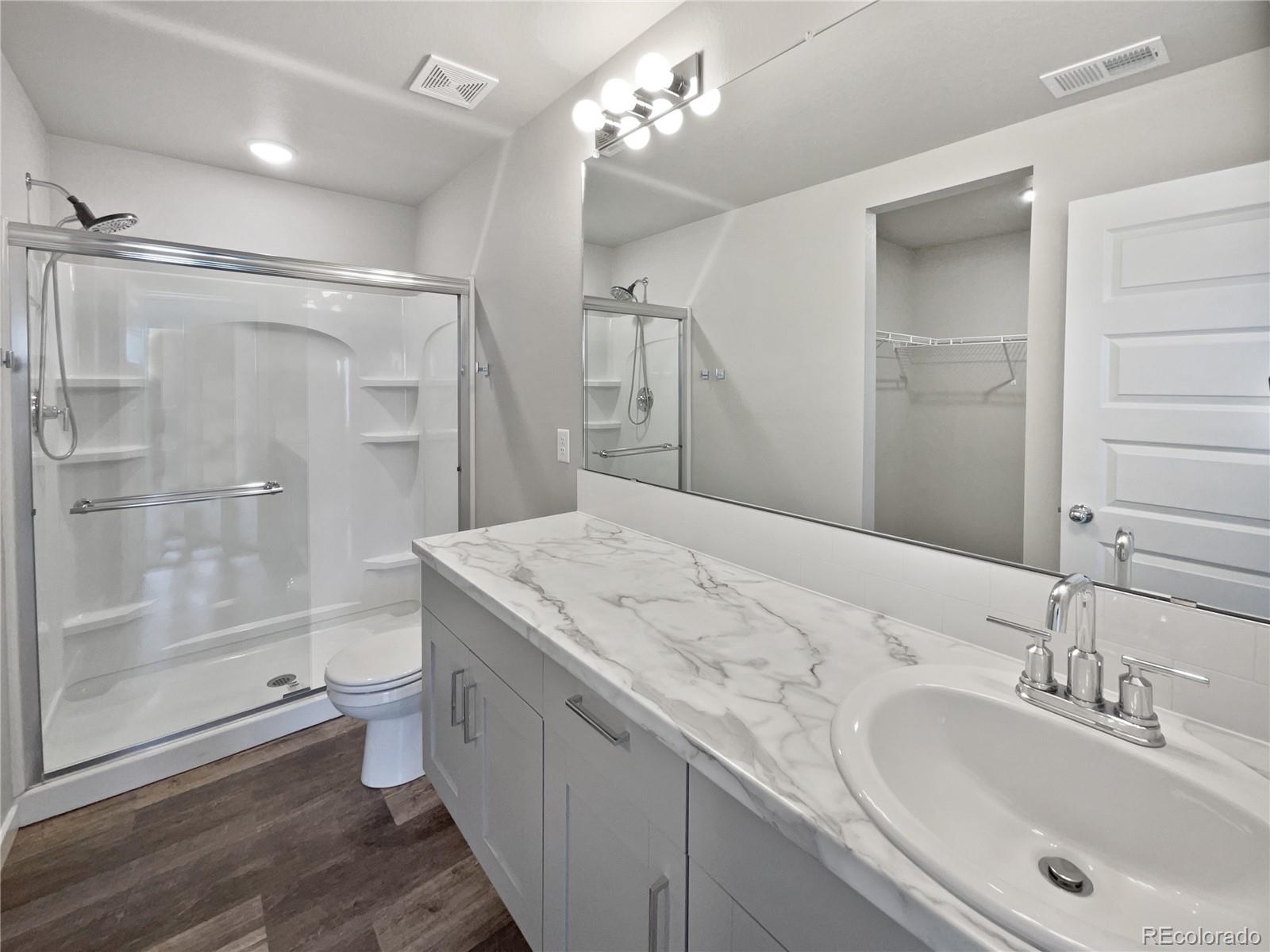 322 Bozeman Trail Ault, CO 80610 - Photo 18 of 19 a bathroom with a sink a toilet and shower