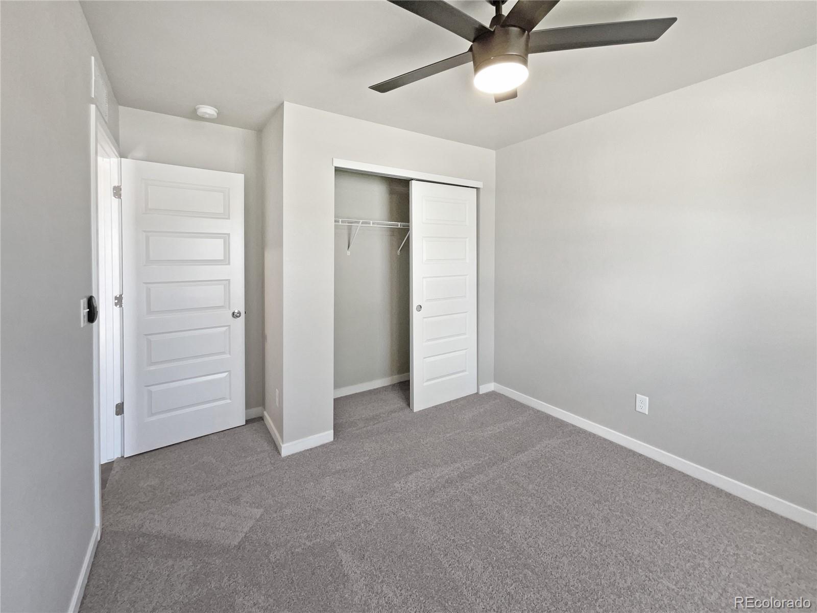 322 Bozeman Trail Ault, CO 80610 - Photo 9 of 19 an empty room with closet and ceiling fan
