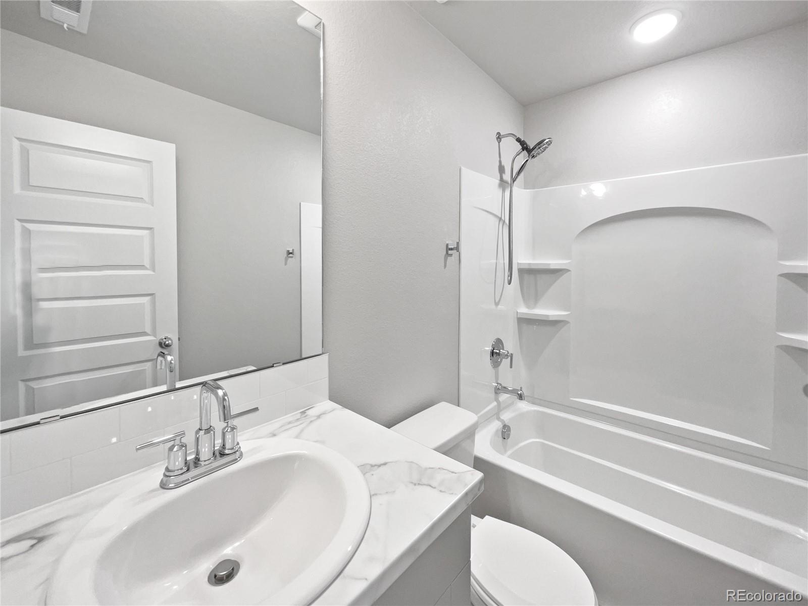 322 Bozeman Trail Ault, CO 80610 - Photo 10 of 19 a bathroom with a granite countertop sink toilet and shower