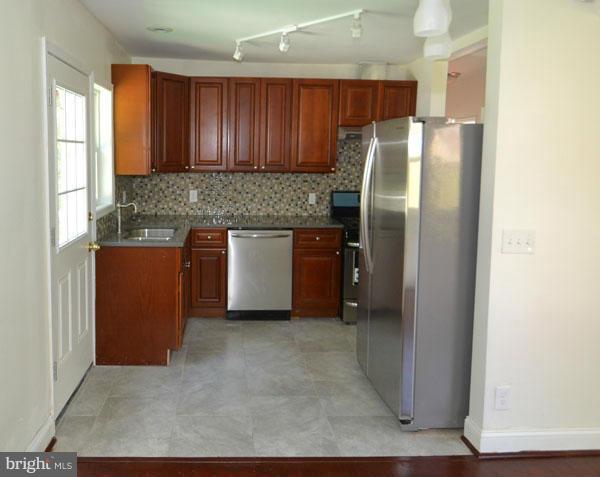 4405 Wakefield Road Baltimore, MD 21216 - Photo 4 of 17 a kitchen with stainless steel appliances granite countertop a refrigerator and a sink