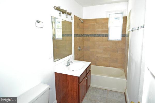 4405 Wakefield Road Baltimore, MD 21216 - Photo 9 of 17 a bathroom with a tub sink and mirror