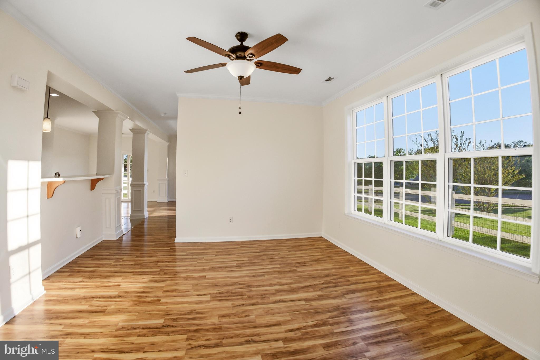 152 Springfield Circle Middletown, DE 19709 - Photo 5 of 29 a view of an empty room with wooden floor and a window