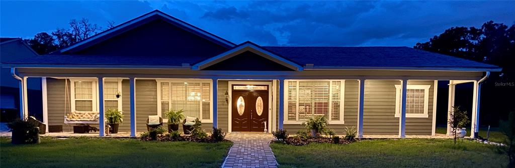 5785 Gilliam Road Orlando, FL 32818 - Photo 2 of 100 a front view of a house with a garden
