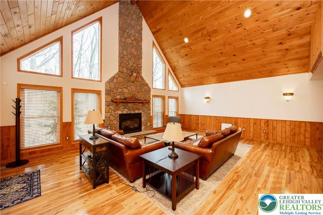 a kitchen with stainless steel appliances granite countertop a refrigerator a stove and a wooden floors