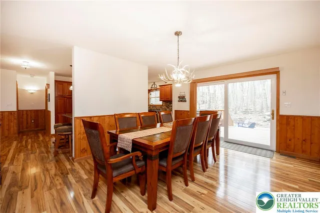a spacious bedroom with a bed and a chandelier