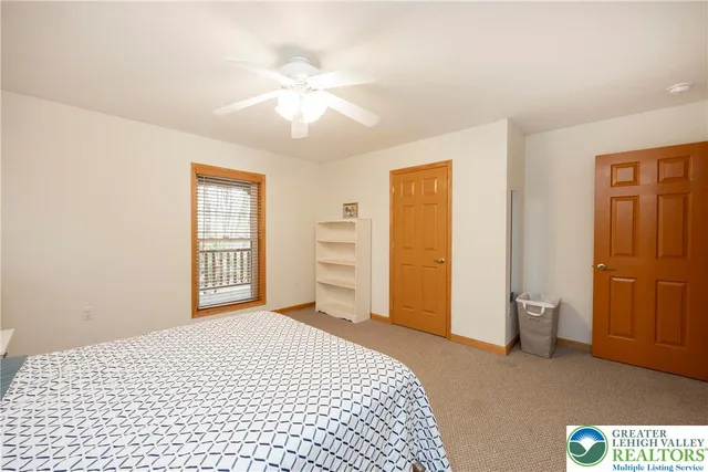 a bedroom with a bed dresser and a window