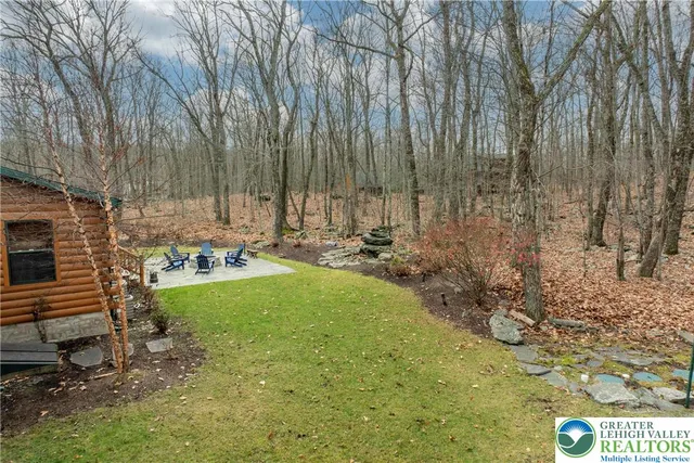 a view of a patio with table and chairs with wooden floor and fence