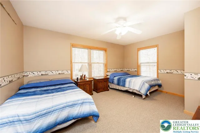 a room with furniture pool table flat screen tv and a wooden floor